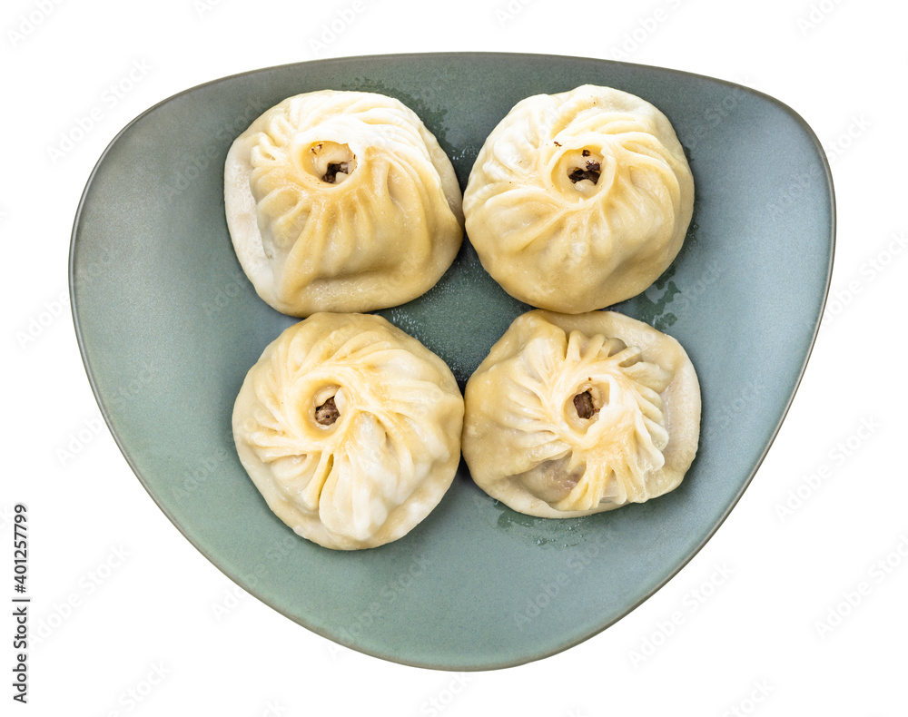 top view of steamed Buuz (Mongolian dumpling filled with minced meat) on green plate isolated on white background top view of steamed Buuz (Mongolian dumpling filled with minced meat) on green plate isolated on white background