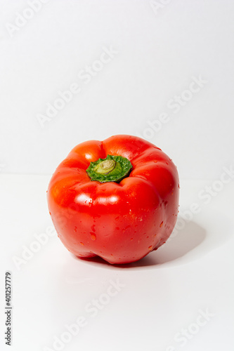 Red ball pepper with white background signifying freshness and vegan diet