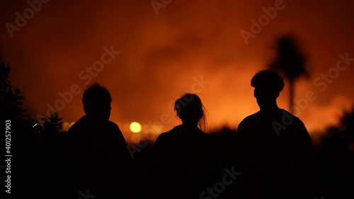 People watch massive fire burning at river bottom in Ventura, CA. 