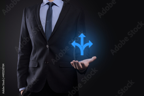 Businessman in a suit holds a sign showing three directions. in doubt, having to choose between three different choices indicated by arrows pointing in opposite direction concept. three ways to choose