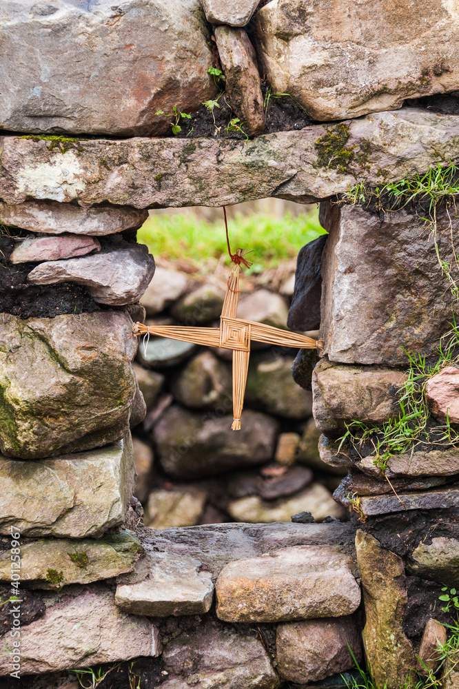 Saint Brigid's cross made from straw stuck in window and blessed the house and protected it from fire and evil. Concept: religion, irish, traditional - obrazy, fototapety, plakaty 