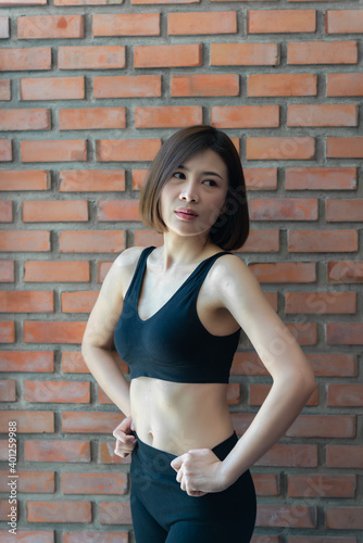 Close up asian beautiful sport girl on wall of gym,Thailand love health,Slim woman workout concept © reewungjunerr