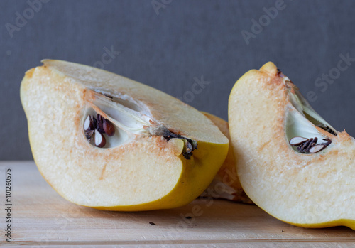 one sliced yellow quince with seeds photo