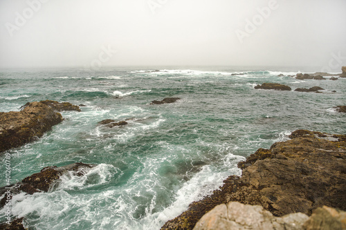 The Pacific Ocean coast in the city of Monterey in California. United States of America. Beautiful beach on a sunny day. Ocean landscape.