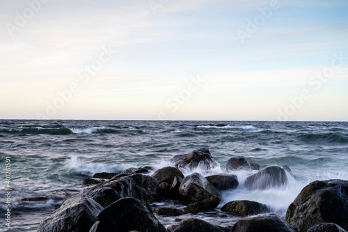 Waves crashing into boulders, long exposure