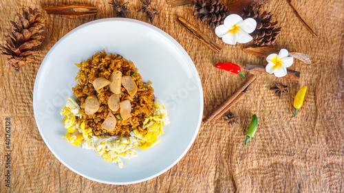 Fried Rice on wood table. Fried rice nasi goreng with chicken and fried meatballs on a plate