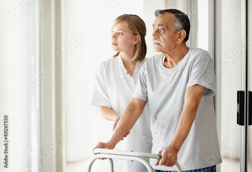Nurse assisting patient with a walker