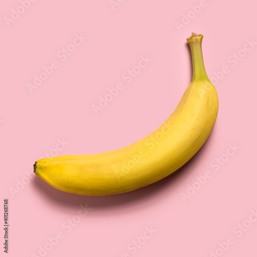 Ripe banana on pink background photo