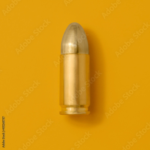 Gold bullet on yellow background
