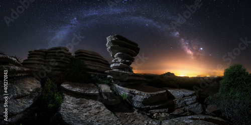 Majestic scenery of rocky terrain with colorful Milky Way on background in Iceland