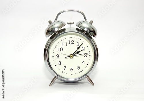 Vintage, analog alarm clock isolated on white background.