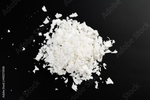 white artificial synthetic snow on black background