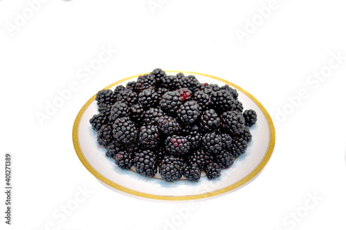 Blackberries lying on a saucer with a gold border