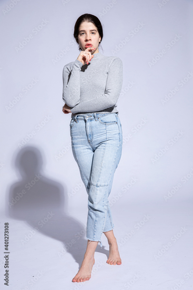 Dark hair caucasian girl on grey