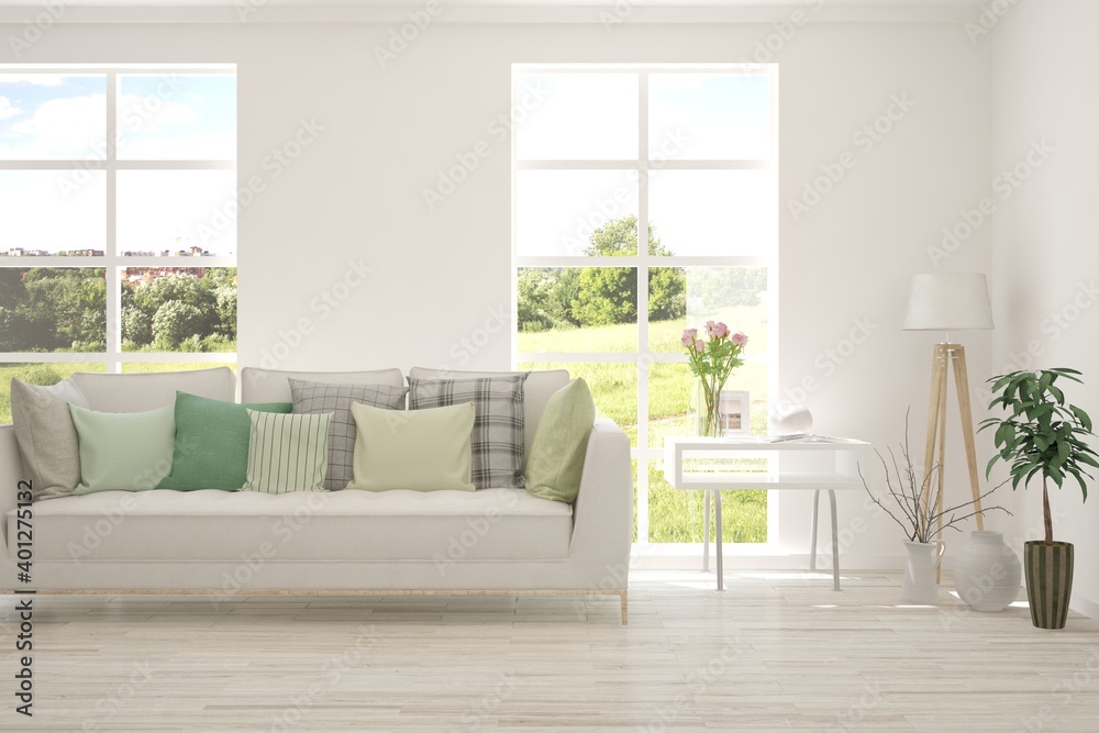 Fototapeta premium White living room with sofa and summer landscape in window. Scandinavian interior design. 3D illustration