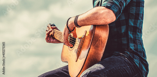 Man's hands playing acoustic guitar, close up. Acoustic guitars playing. Music concept