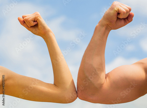 Sporty man and woman. Muscular arm vs weak hand. Vs, fight hard. Competition, strength comparison. Rivalry concept. Rivalry, vs, challenge, strength comparison