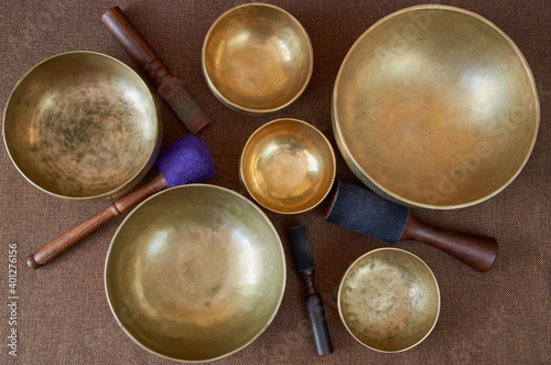 Sound healing music  instruments for meditation  relaxation  yoga  massage  sound healing - tibetan singing bowls with sticks on the dark background