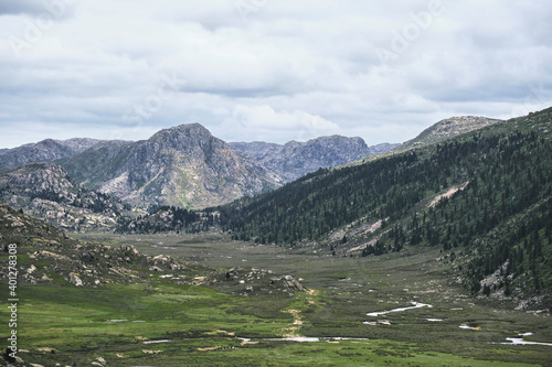 Majestic breathtaking scenery of picturesque nature of hills and peaks under blue sky in Tibetan area