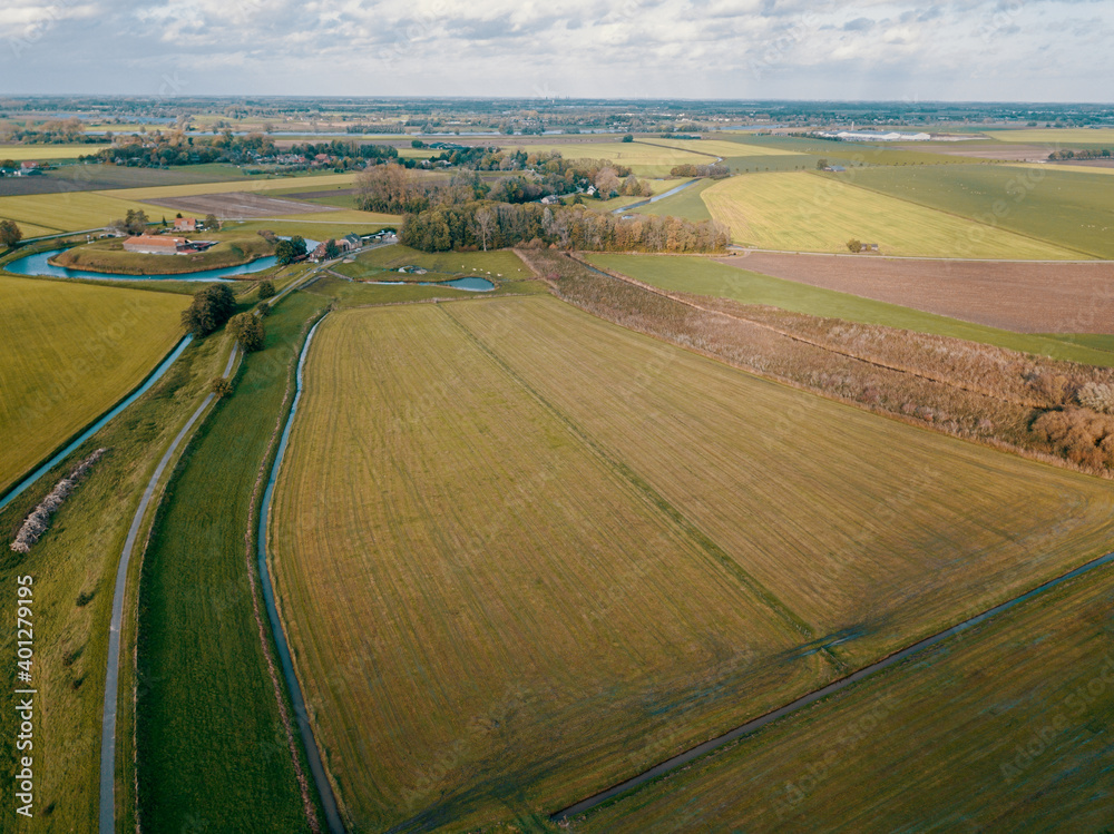 Aerial drone shot of the beautiful farm fields area in the Netherlands. 
