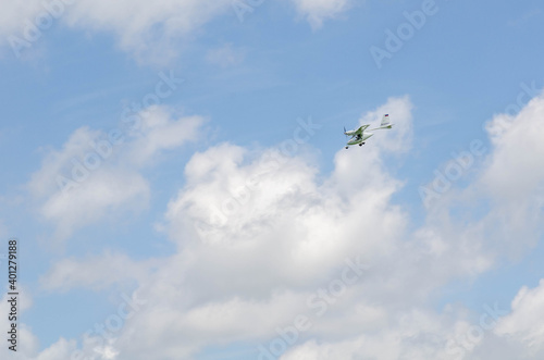 Small aircraft plane soars, flies in the sky among the clouds