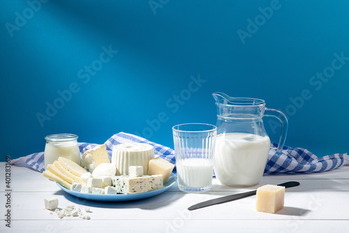 Dairy products on white wood base and blue background. photo