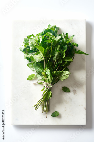 A bunch of fresh mint on marble cutting board