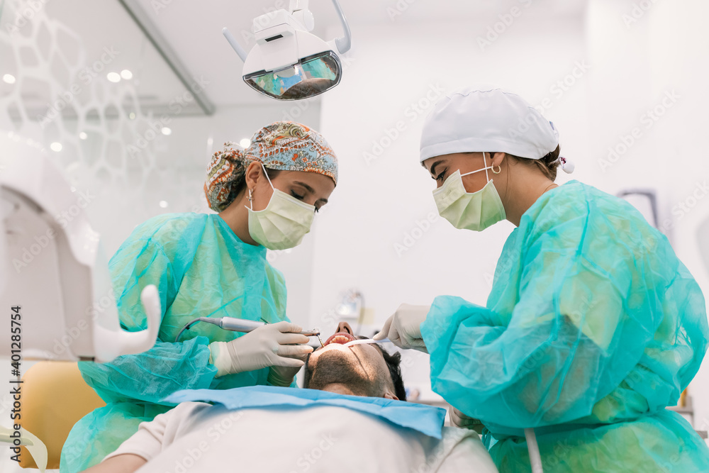 Young Female patient with open mouth examining dental inspection Young Female patient with open mouth examining dental inspection