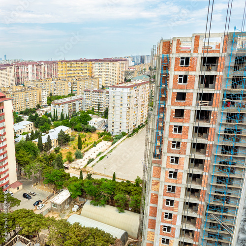 High buildings scaffold at the construction site, city view