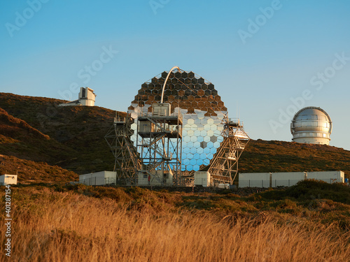 Various modern telescopes including MAGIC or Major Atmospheric Gamma Imaging Cherenkov Telescope located on hill slope at astronomical observatory on island of La Palma in Spain photo