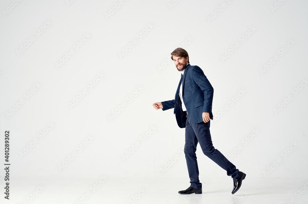 business man in a suit goes to the side on a light background side view Copy Space business man in a suit goes to the side on a light background side view Copy Space