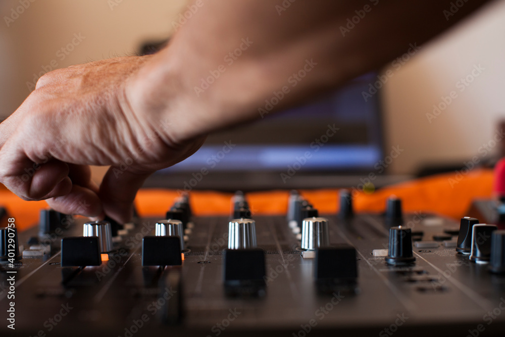 Hands of a DJ on a mixing console Hands of a DJ on a mixing console