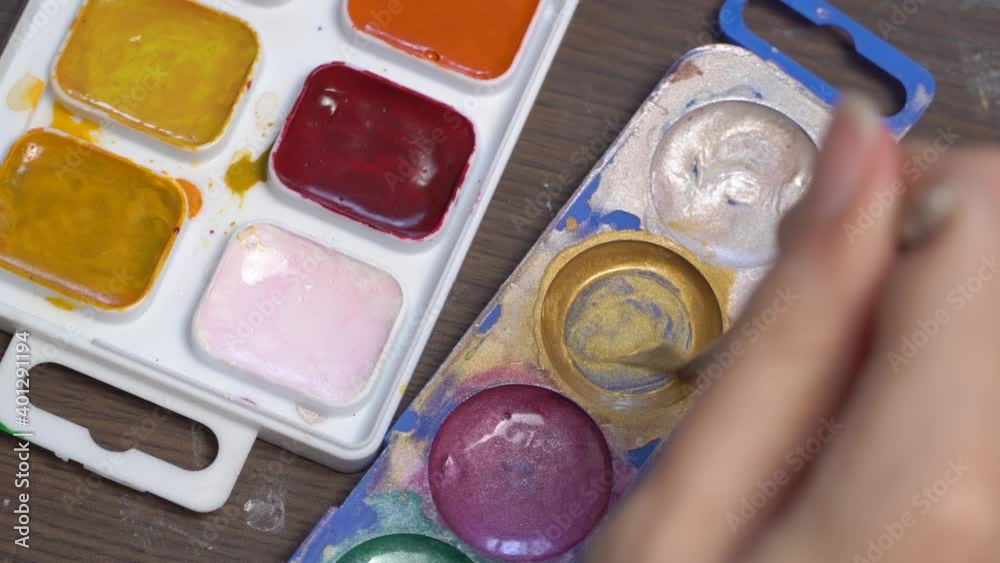 The artist draws paint on the brush. Close-up brush and watercolors. Hobbies and creativity. The artist's stained paint. Do it yourself. Design, inspiration. Artwork. Idea, concept. Draw a picture The artist draws paint on the brush. Close-up brush and watercolors. Hobbies and creativity. The artist's stained paint. Do it yourself. Design, inspiration. Artwork. Idea, concept. Draw a picture