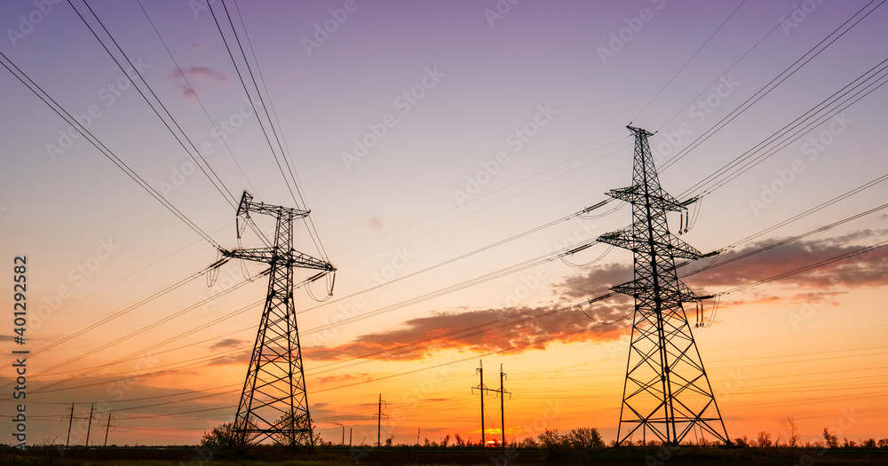 distribution electric substation with power lines silhouette on the dramatic sunset background