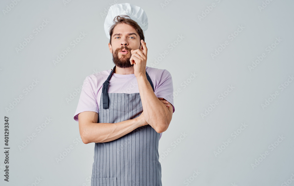 professional chef man in a headdress on a light background cropped view professional chef man in a headdress on a light background cropped view