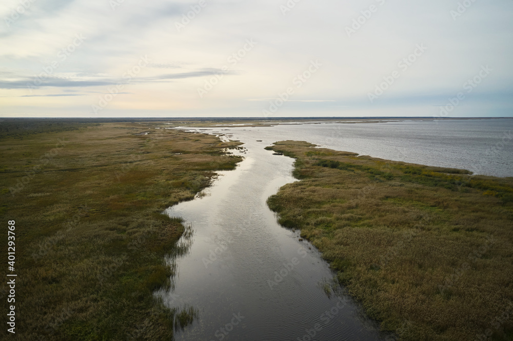 Wonderful drone view of calm river flowing into sea under peaceful sunset sky Wonderful drone view of calm river flowing into sea under peaceful sunset sky