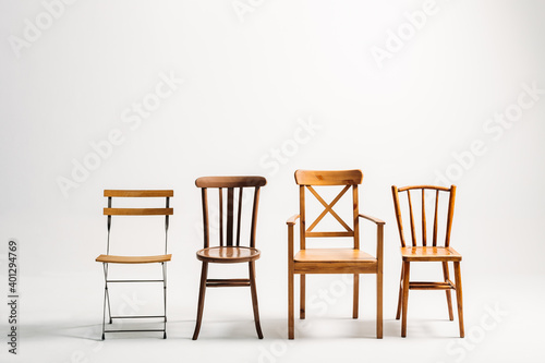 Four classical wooden chairs against white background