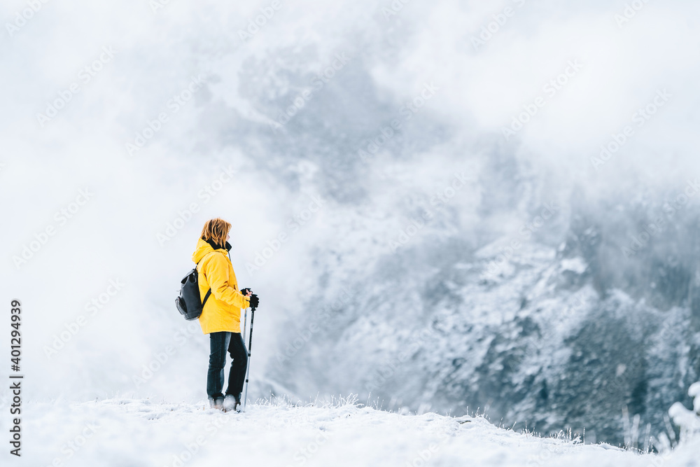 Side view of anonymous hiker with trekking poles walking on snowy ground in Pyrenees mountains in Andorra Side view of anonymous hiker with trekking poles walking on snowy ground in Pyrenees mountains in Andorra