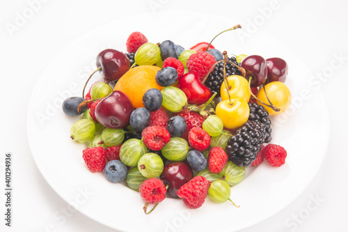 assortment of fresh berries on a white plate. useful vitamin healthy food fruit. healthy vegetable breakfast