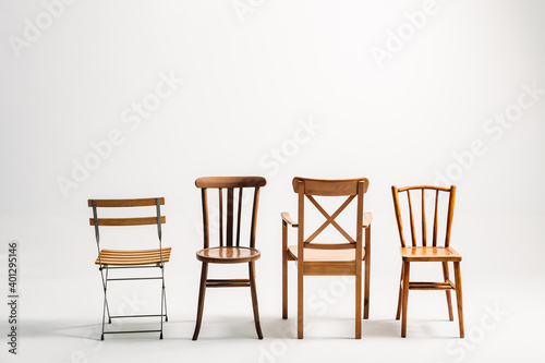 Four classical wooden chairs against white background photo