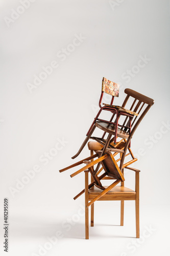 Set of old chairs stacked against white background