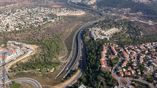 Highway in the mountains with red rooftops, Aerial view Jerusalem tel aviv highway (road one) traffic, Israel,drone view 