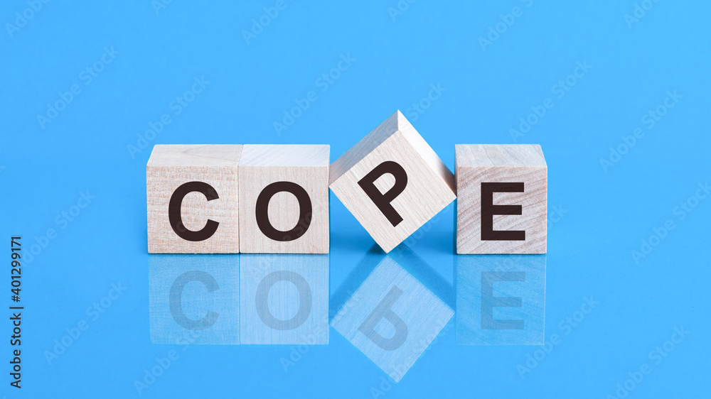 Cope from wooden letters on black background. Social concept.