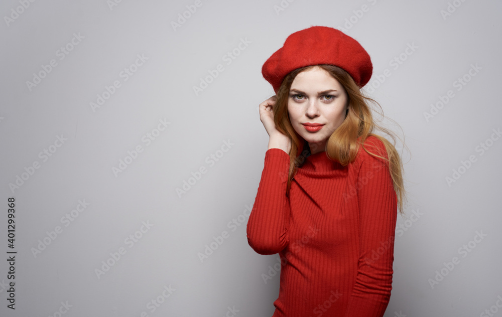 Attractive attractive woman in red dress and in a hat luxury glamor cosmetics Attractive attractive woman in red dress and in a hat luxury glamor cosmetics