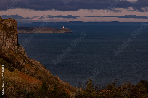 Fairhead  Rathlin Island East Lighthouse and The Isle of Islay in Scotland from Murlough Bay  Causeway coastal route  Causeway coast and Glens  County Antrim  Northern Ireland