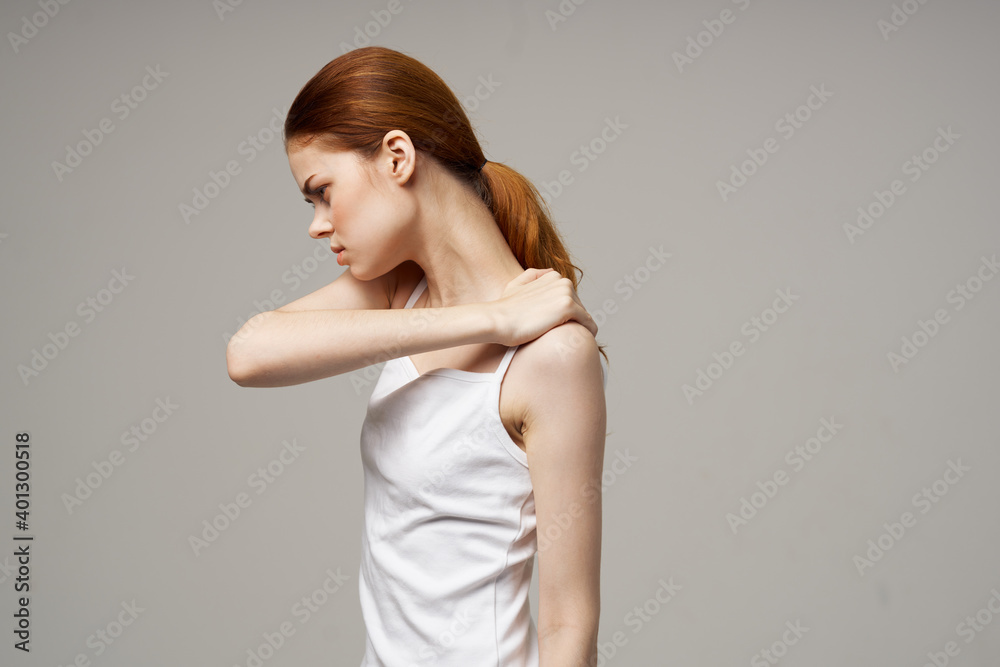 Fototapeta premium woman holding herself by the shoulders on beige background cropped view