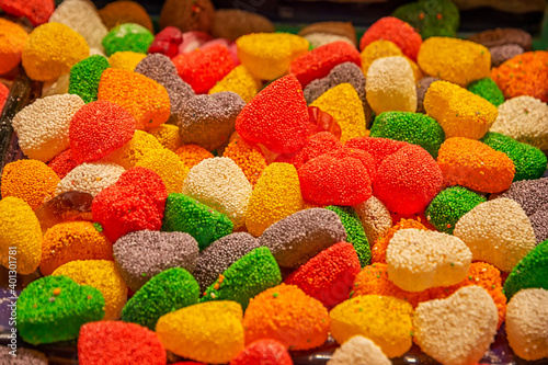 Many colorful sweets with sugar and flavor fruit. Horizontal view.