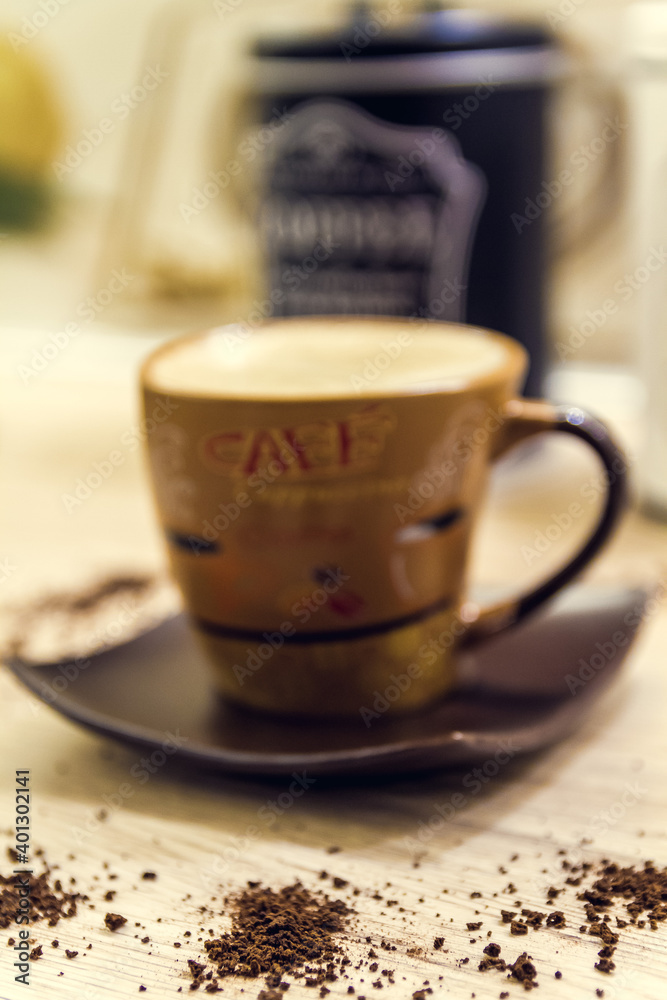 A cup of coffee on a wooden surface in the kitchen. Home made espresso coffee. A cup of coffee on a wooden surface in the kitchen. Home made espresso coffee.