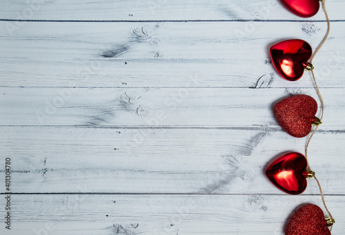 red hearts on a light wooden background. valentine's day