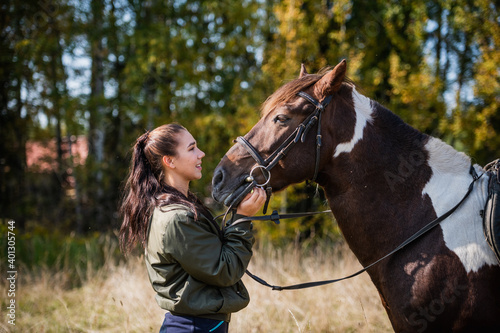 Tender communication between a rider and her horse before a riding lesson.